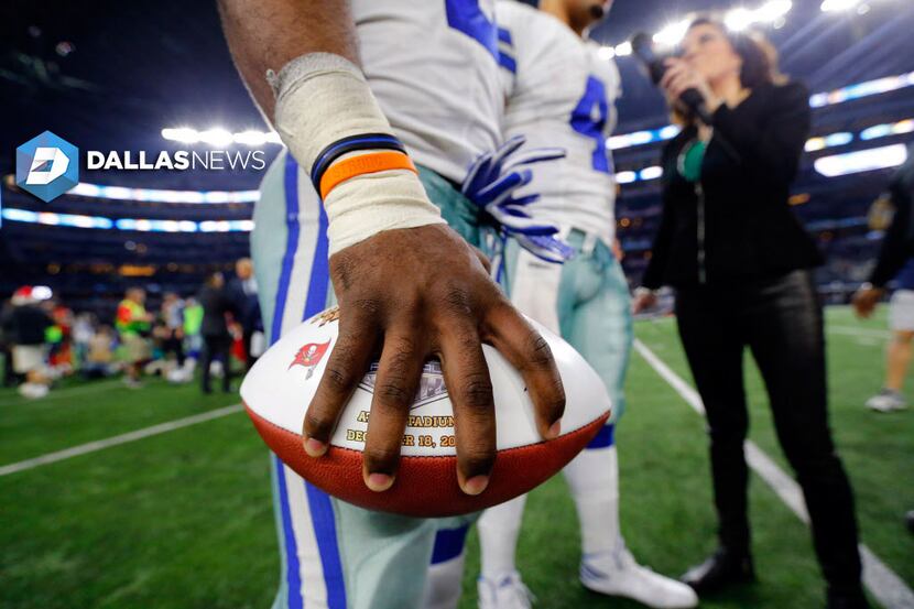 Dallas Cowboys running back Ezekiel Elliott holds the Sunday Night Football game ball tight...