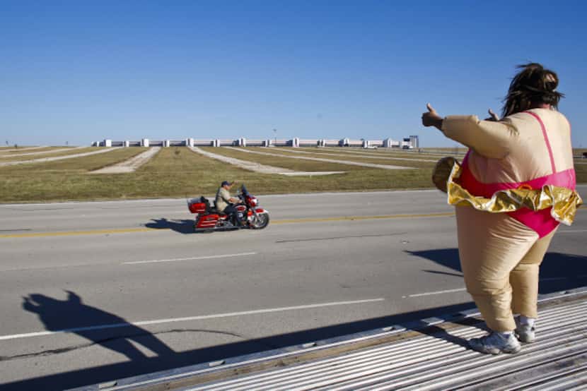 A ballerina fat suit fit the occasion for this NASCAR fan who waved to motorists Friday...