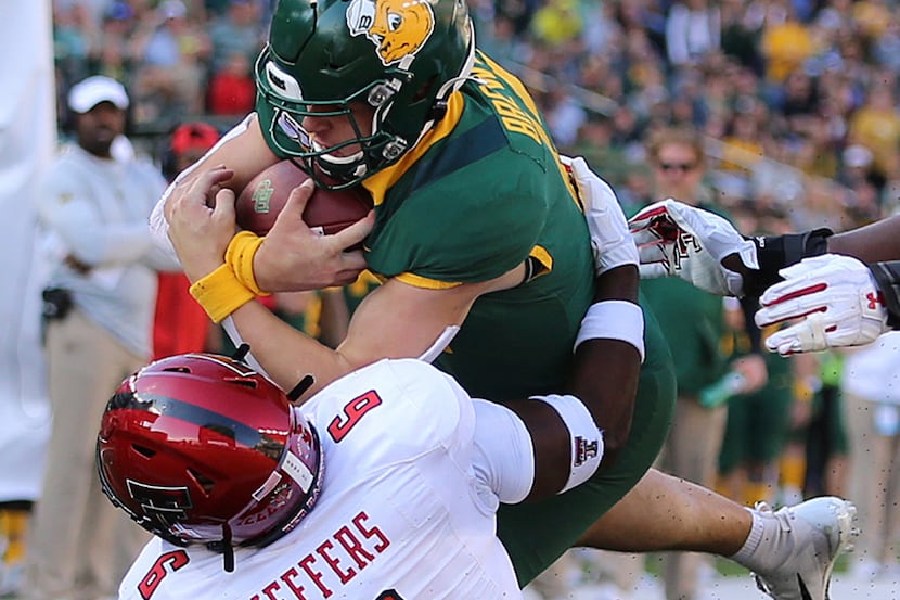 Baylor quarterback Charlie Brewer (12) dives for a touchdown through Texas Tech linebacker...