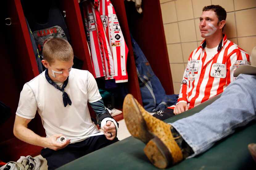 In the Justin Sportsmedicine room, bullfighter Nathan Harp of Tuttle, Oklahoma (left) wraps...