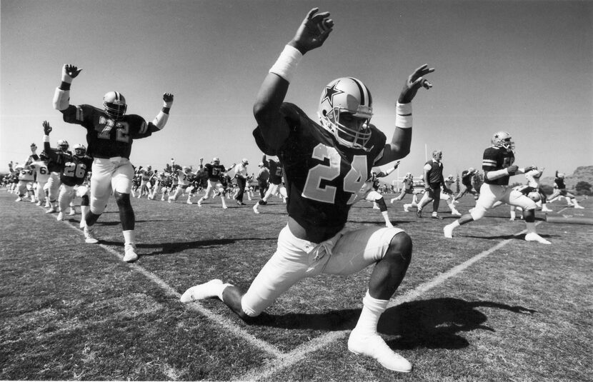 Dallas Cowboys Ed Jones (72), Everson Walls (24) and others go through exercises before...