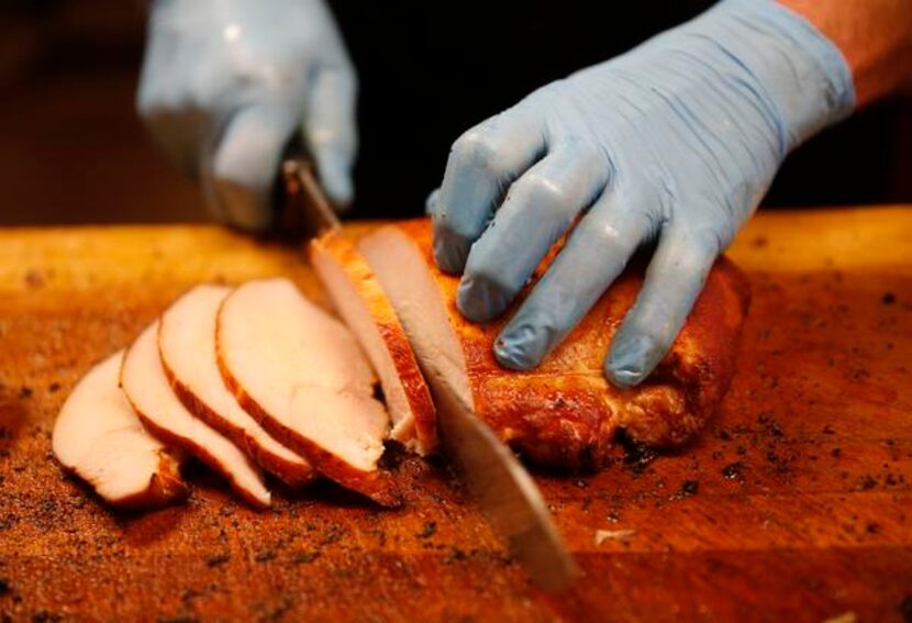 
BBQ on the Brazos pitmaster John Sanford slices smoked tukey.
