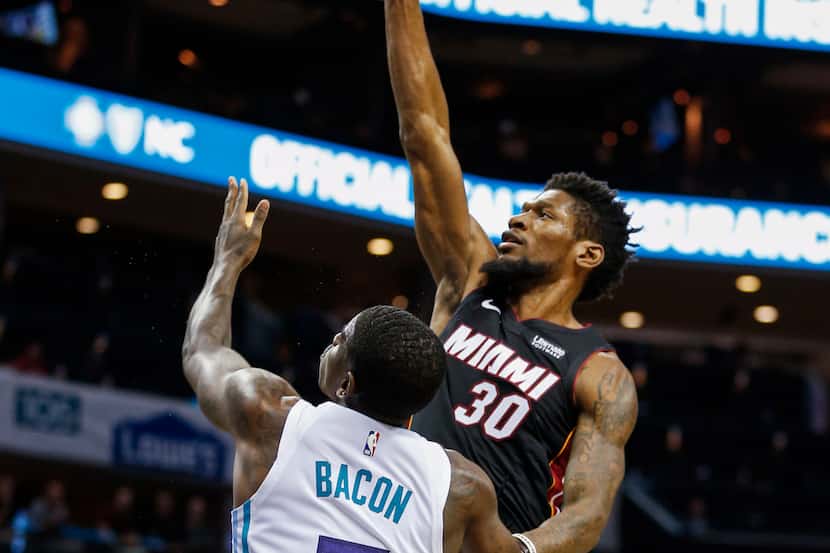 Miami Heat forward Chris Silva (30) shoots over Charlotte Hornets guard Dwayne Bacon during...