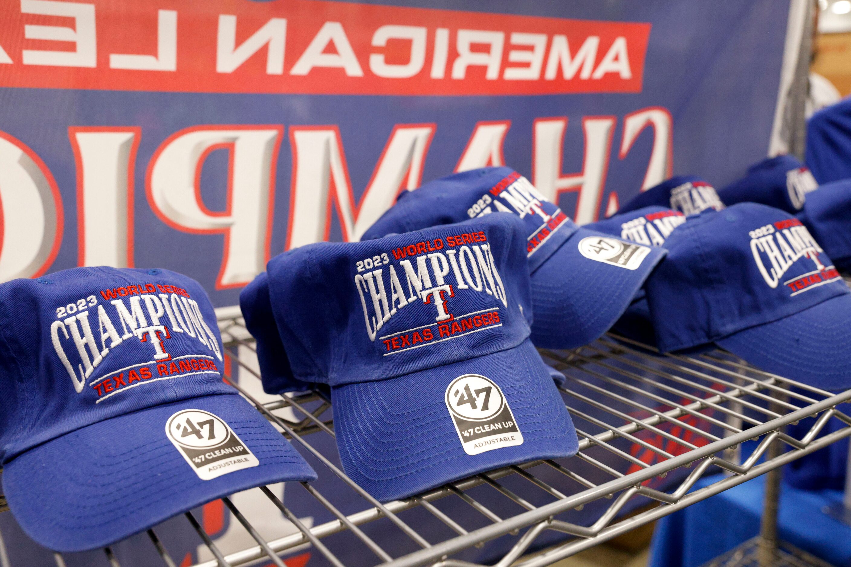 Texas Rangers 2023 World Series champions hats sit for sale at an Academy Sports on...