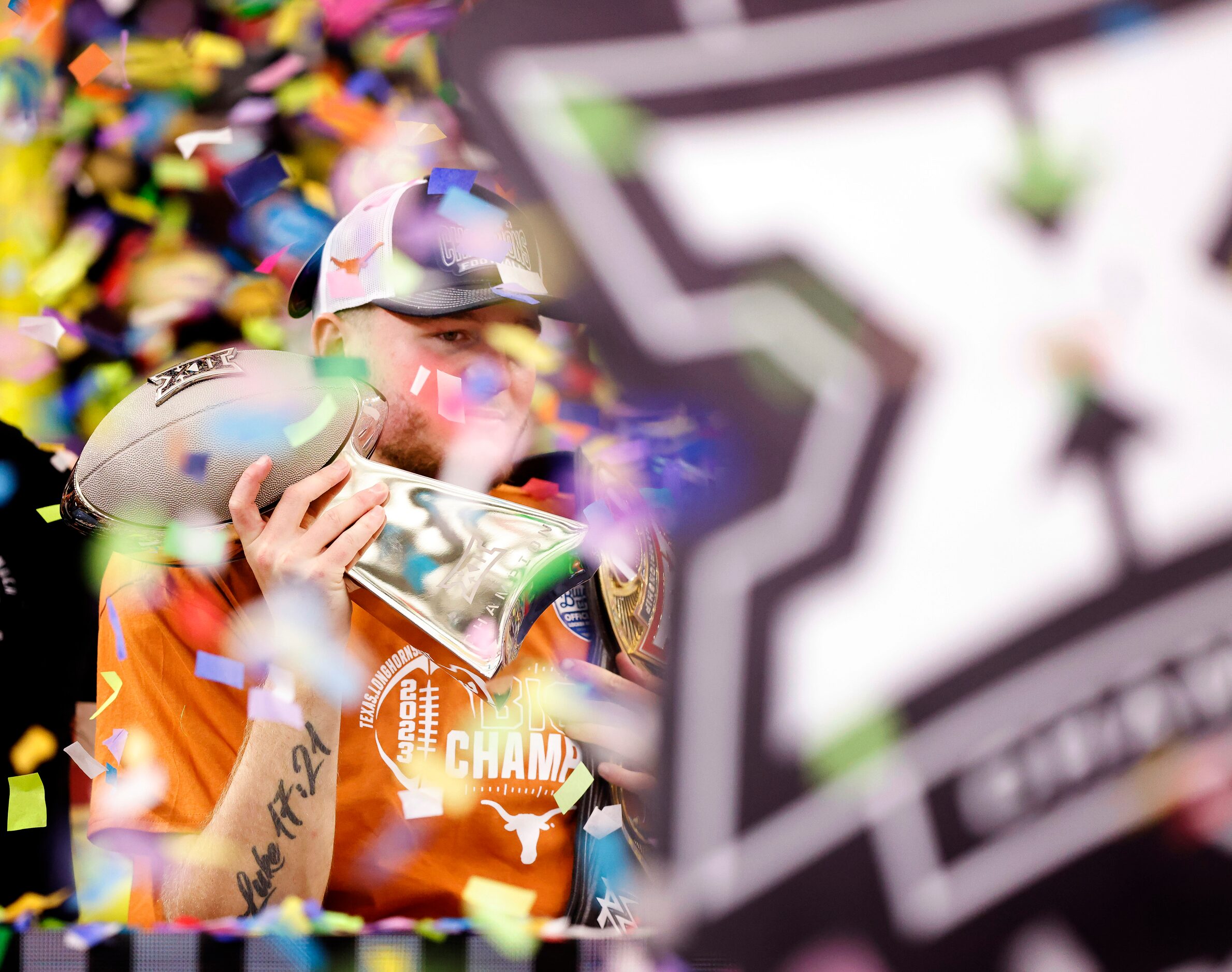 Texas Longhorns quarterback Quinn Ewers (right) hoists Big 12 Championship trophy at AT&T...