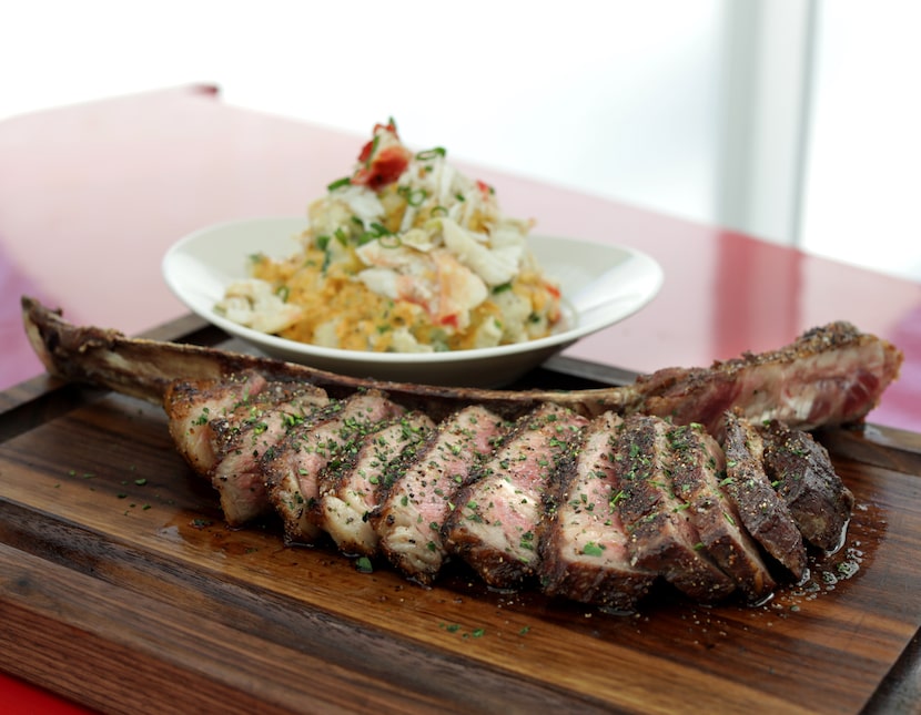 The Bone-in Tomahawk, foreground, and the King Crab Creole mash at Dee Lincoln Prime in Frisco