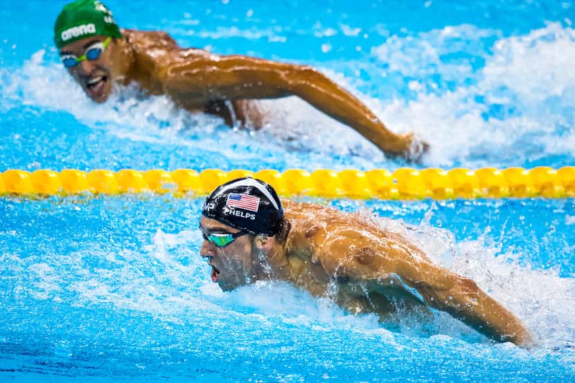 Michael Phelps of the USA leads Chad Guy Bertrand Le Clos of South Africa to the finish of...