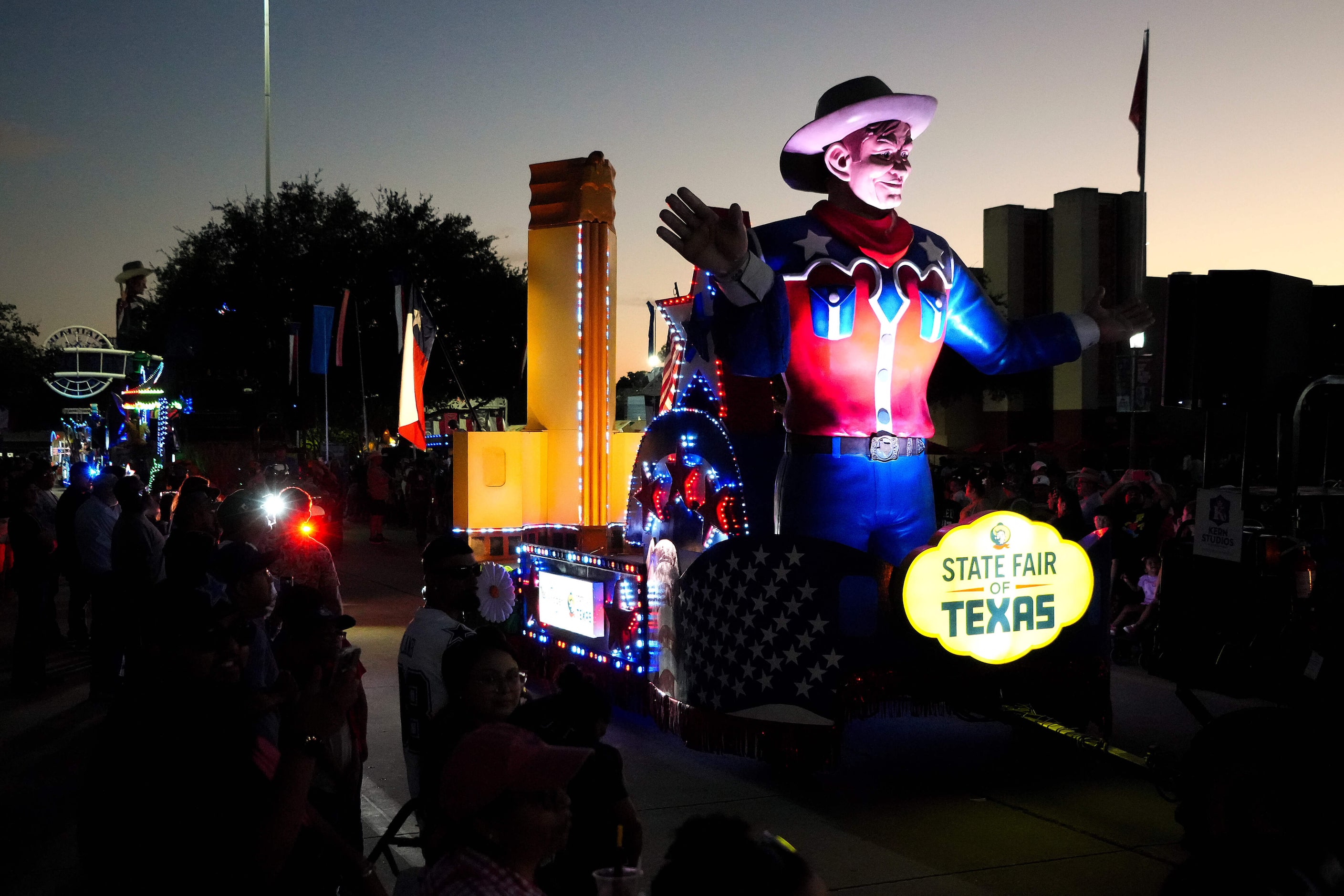 Floats in the Starlight Parade pass the Hall of State at the State Fair of Texas on Sunday,...