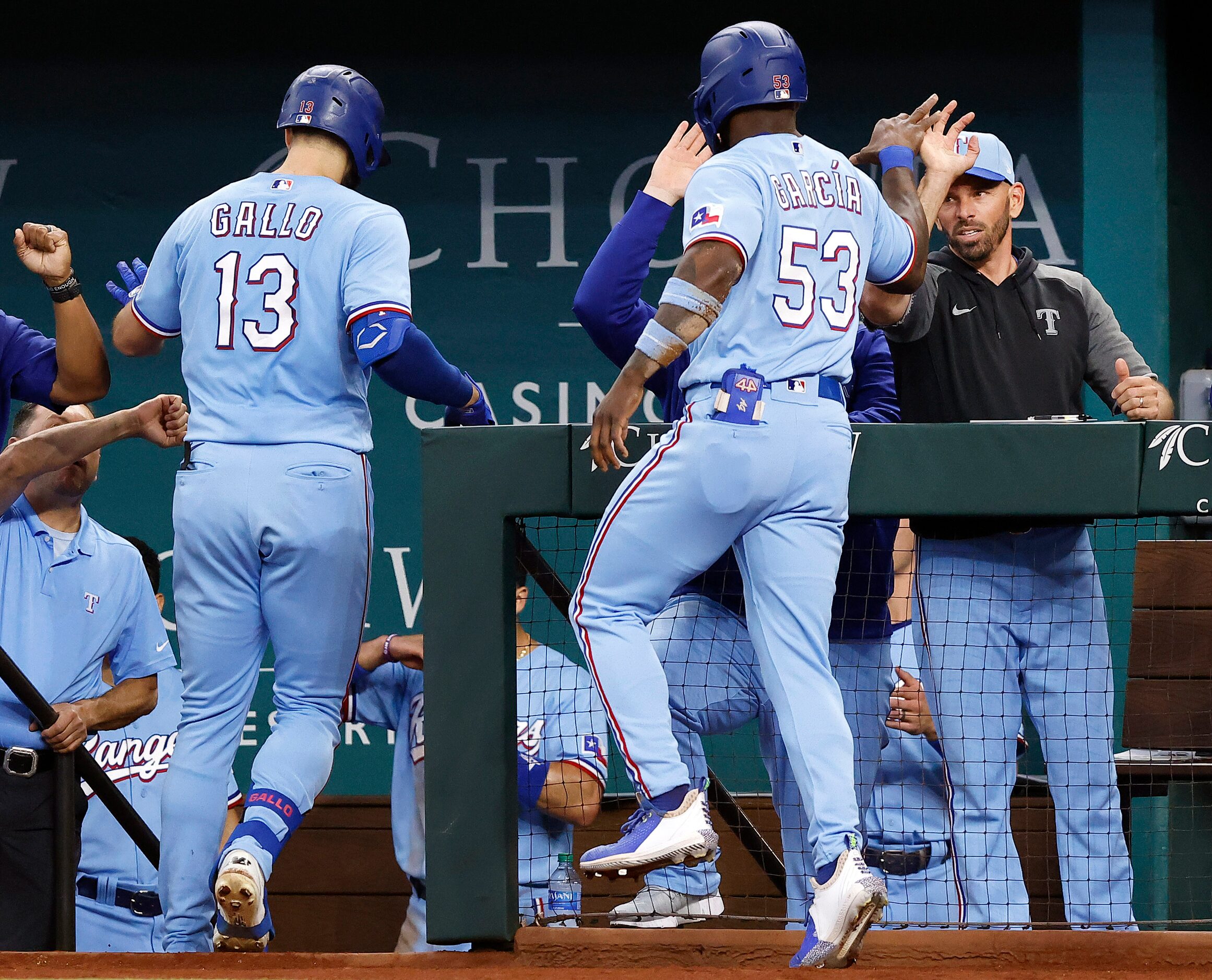 Texas Rangers batter Joey Gallo (13) and Adolis Garcia (53) are congratulated by manager...