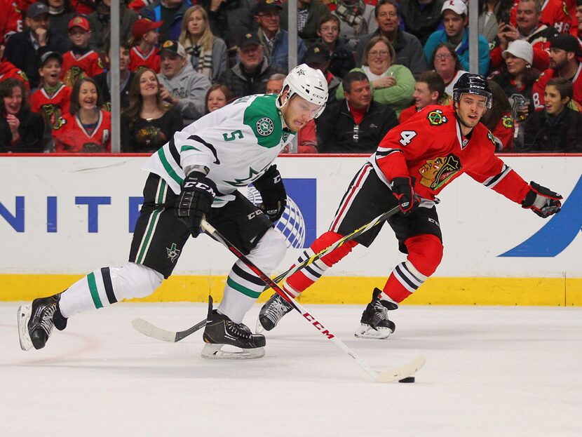 Jan 4, 2015; Chicago, IL, USA; Dallas Stars defenseman Jamie Oleksiak (5) is pursued by...