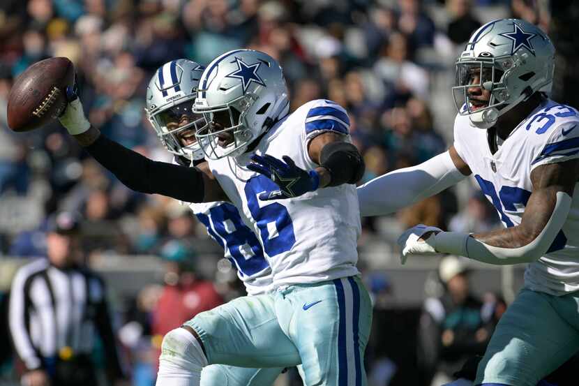 Dallas Cowboys safety Donovan Wilson (6) celebrates a fumble recovery with Ezekiel Elliott...