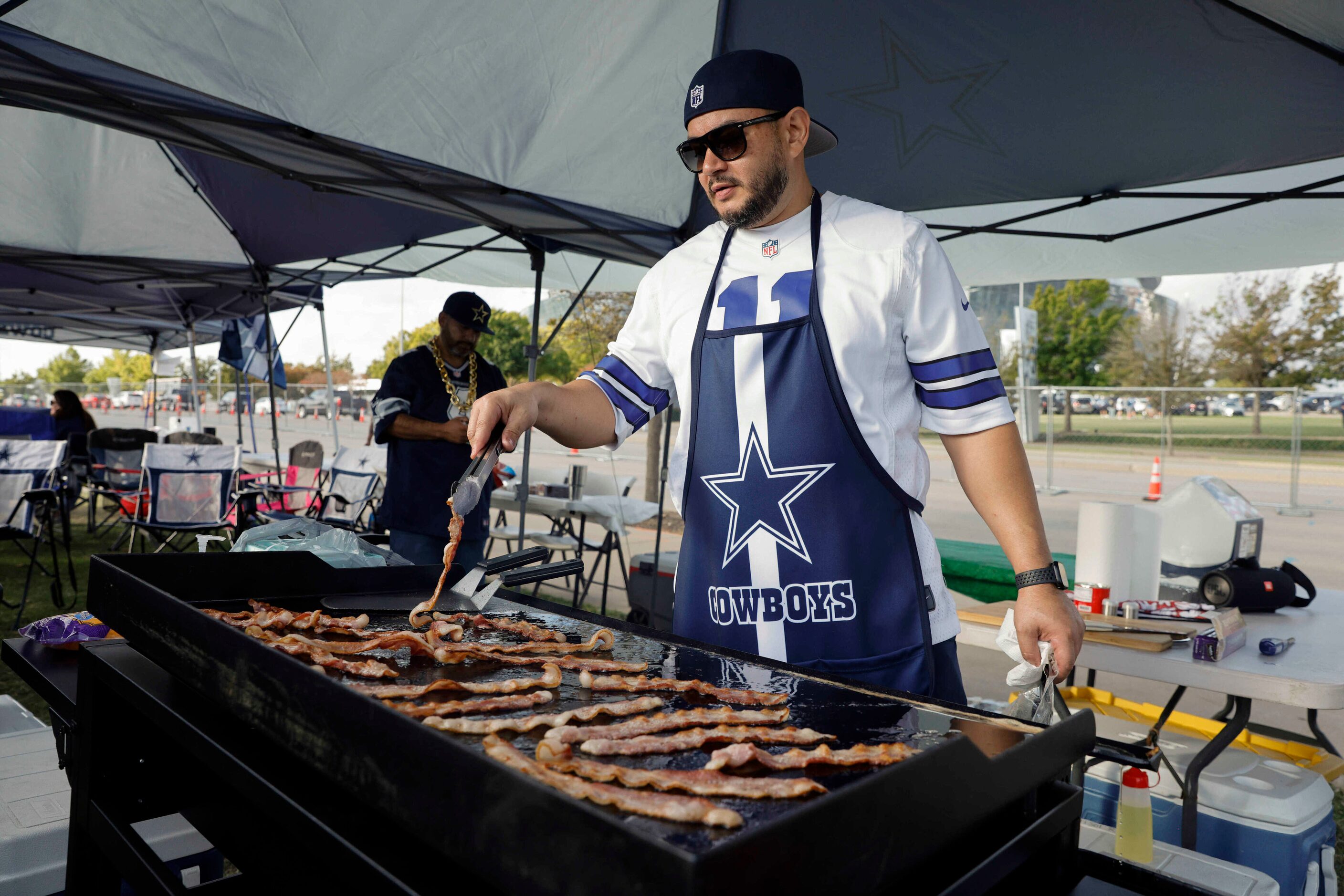 Ricardo Ramirez of Cedar Hill grills before a Dallas Cowboys and Detroit Lions game at AT&T...