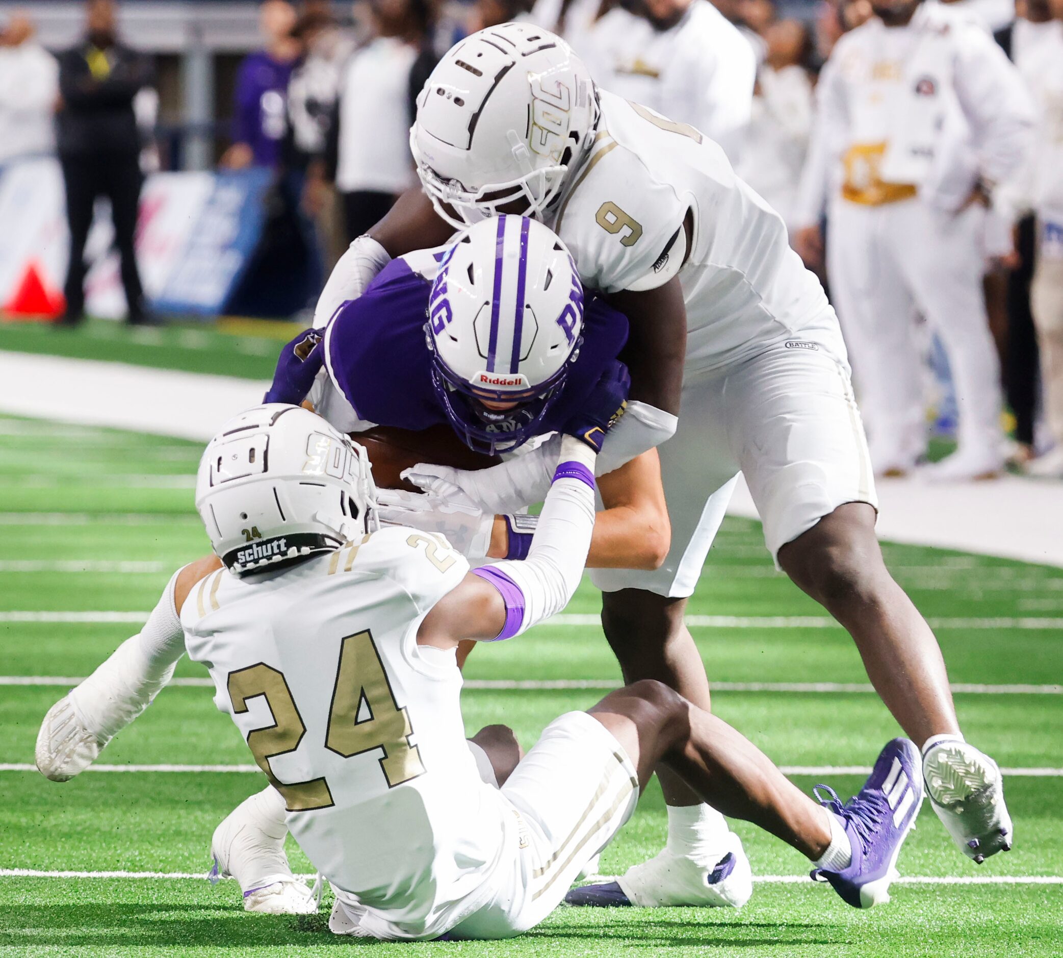 Port Neches-Groves’ QB  Shea Adams (center) is brought down by  South Oak Cliff’s safety...