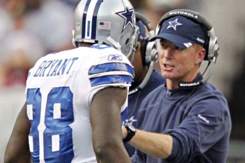 Dallas Cowboys head coach Jason Garrett (right) talks with wide receiver Dez Bryant as he...