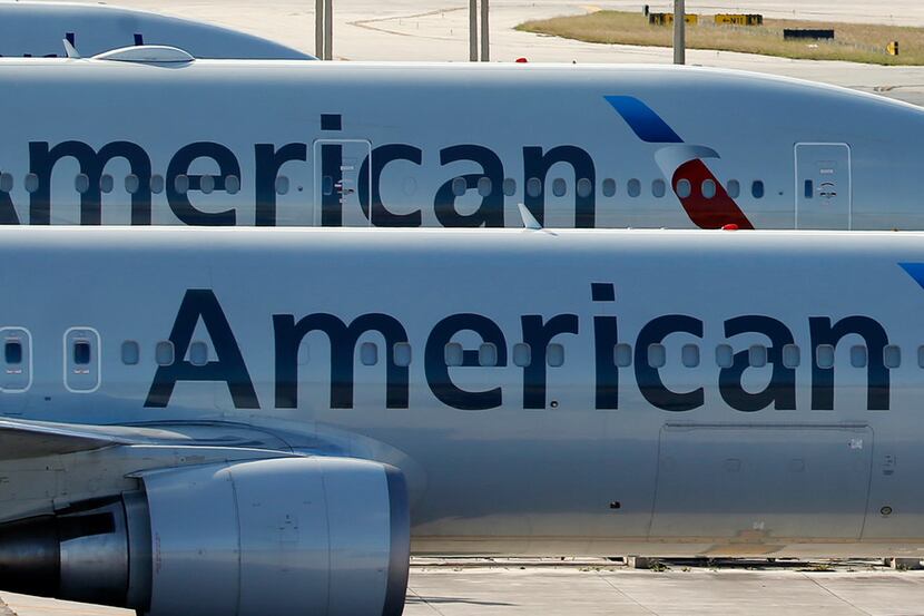 FILE - In this Monday, Nov. 6, 2017, file photo, a pair of American Airlines jets are parked...