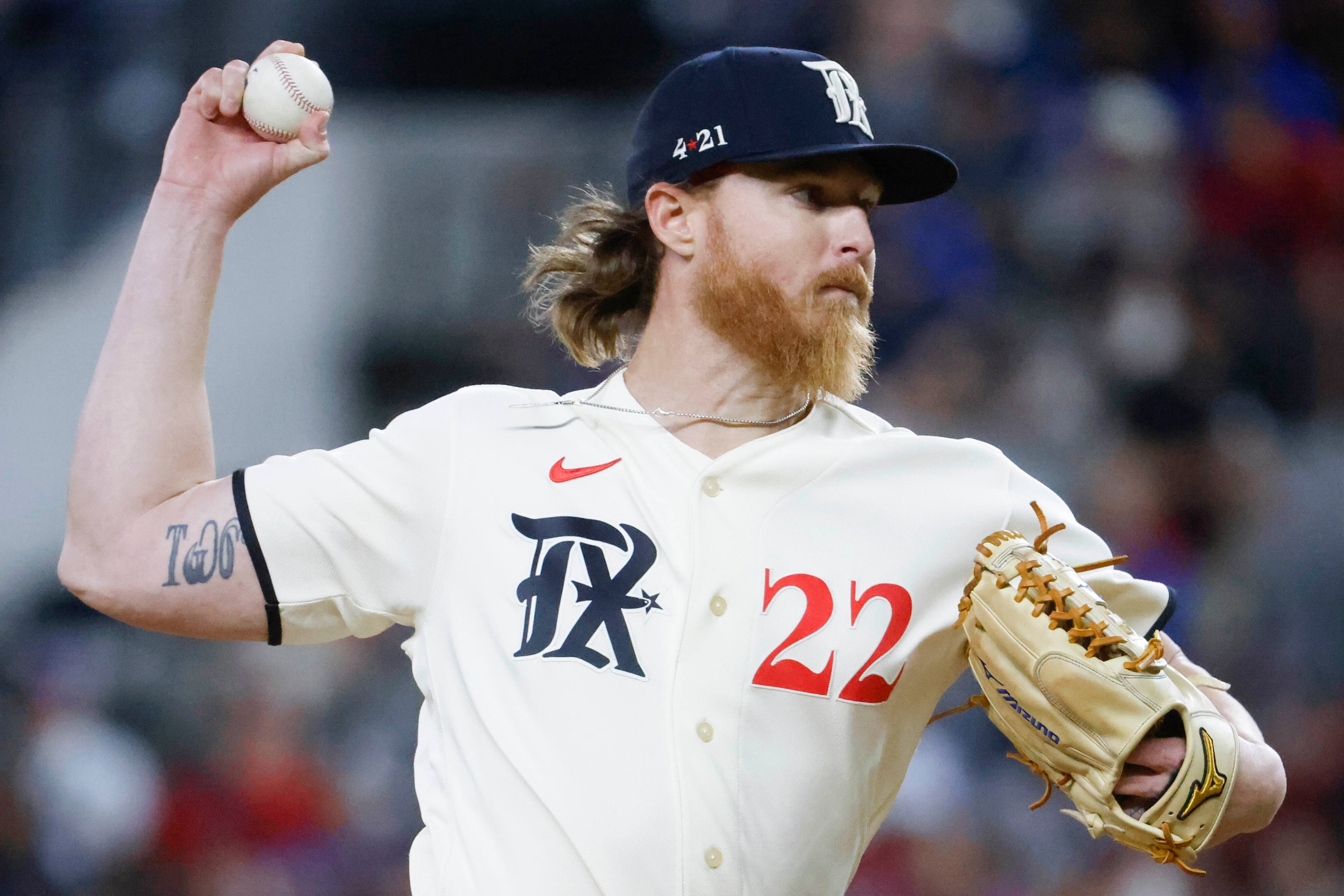 Texas Rangers starting pitcher Jon Gray throws during the third inning of a baseball game...