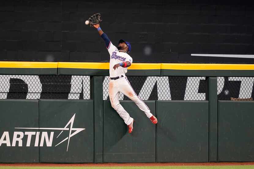Texas Rangers center fielder J.P. Martinez makes a leaping attempt on a two-run home run...
