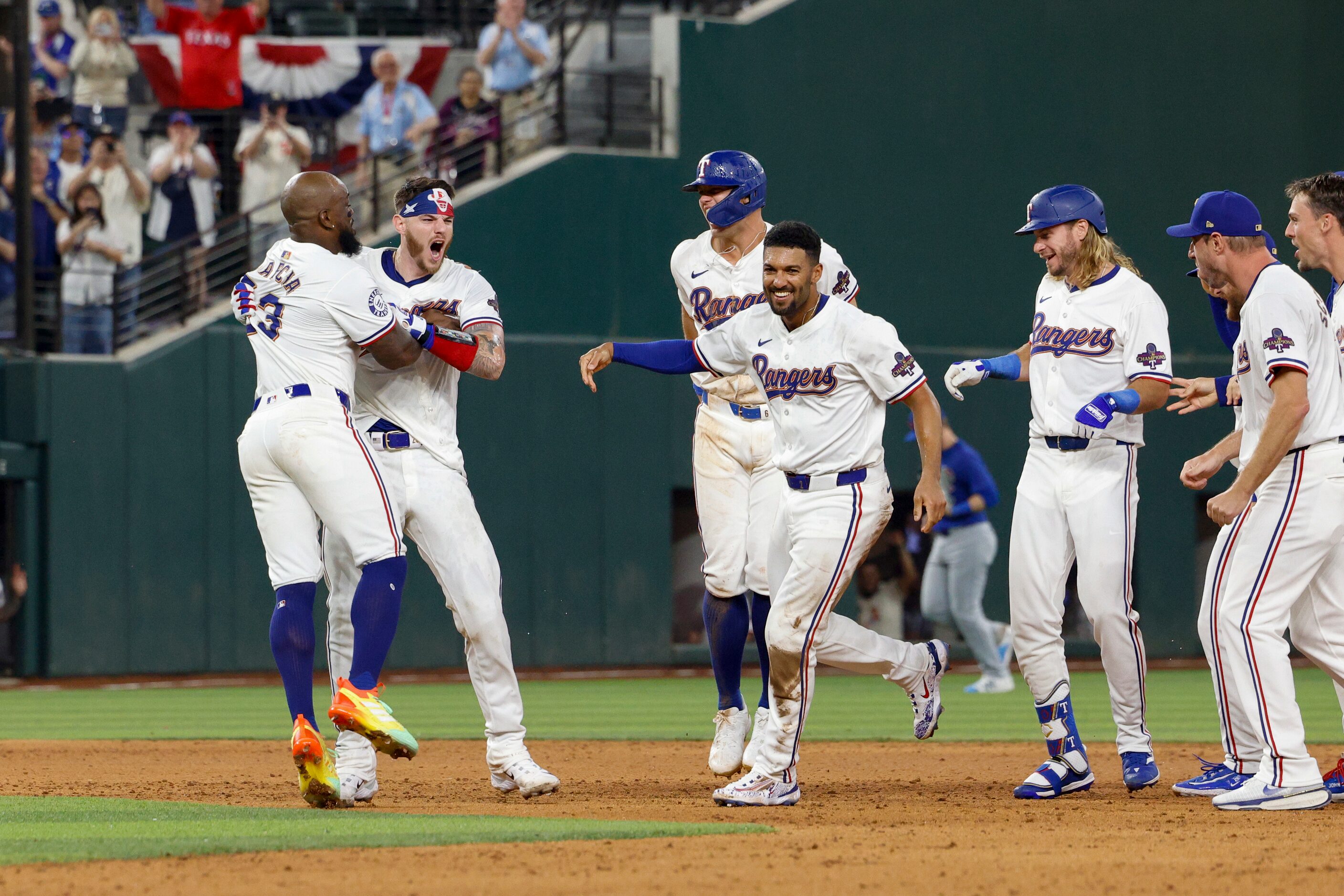 Texas Rangers right fielder Adolis Garcia (53) celebrates catcher Jonah Heim’s game-winning...