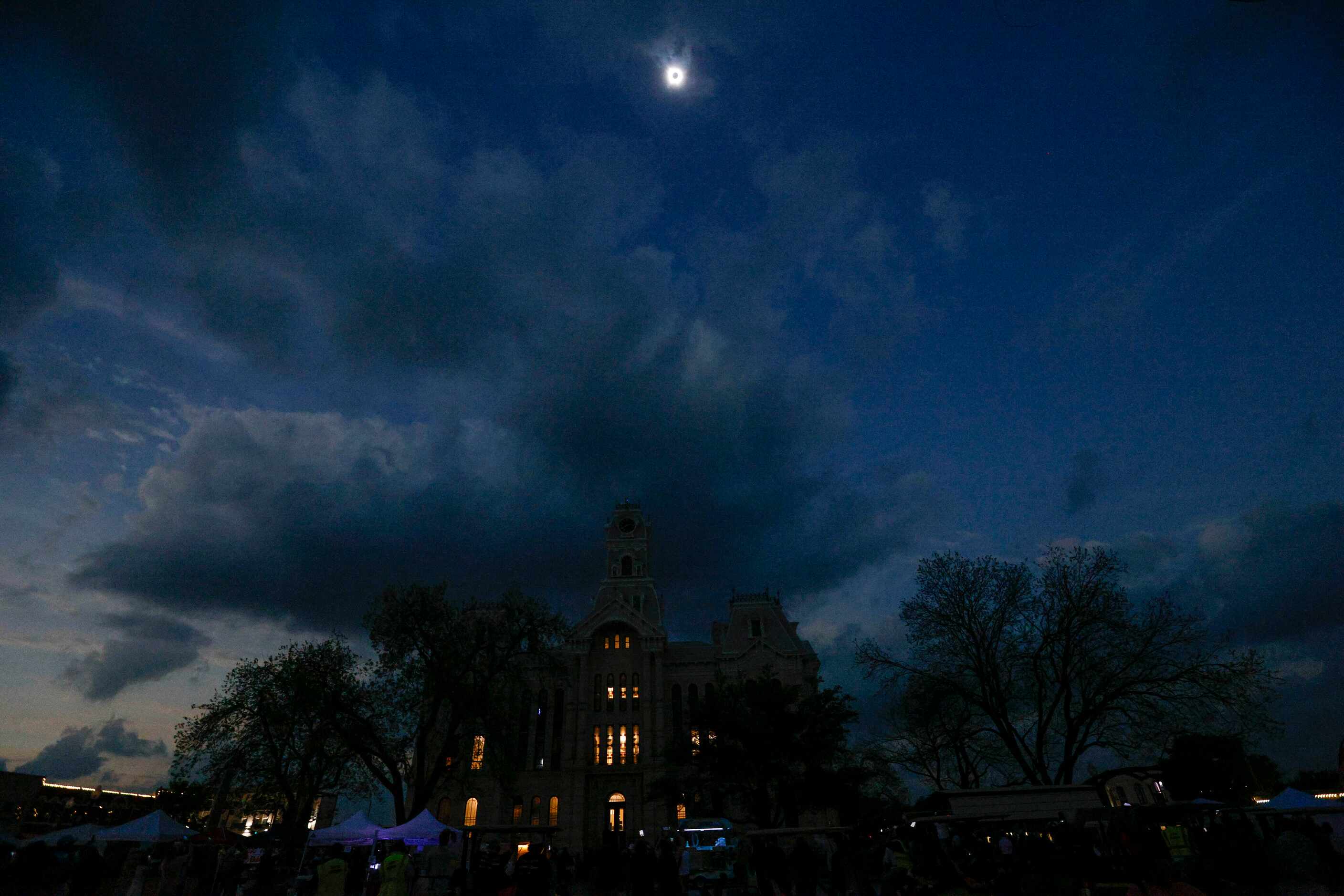 A total solar eclipse is seen over the Hill County Courthouse, Monday, April 8, 2024, in...