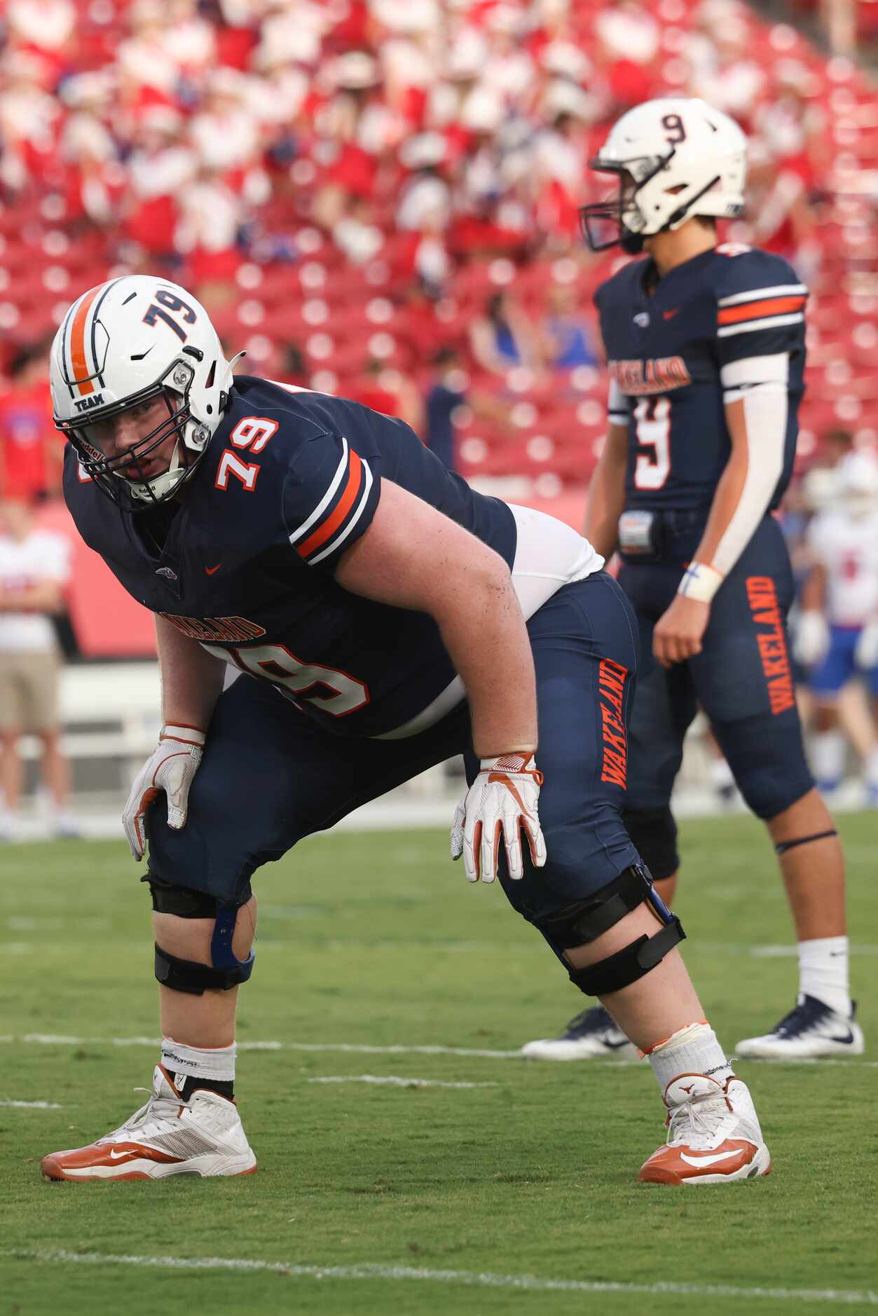 Wakeland High School’s Connor Stroh (79) stands at the line of scrimmage looking to the...