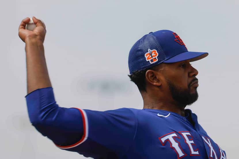 Texas Ranger pitcher Kumar Rocker throws a pitch during a spring training workout at the...