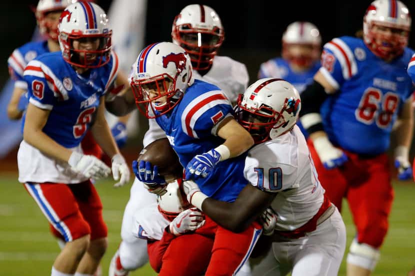 Richardson Pearce's Martinez Hill (5) is tackled by Skyline' defender Caleb Hart (10) during...