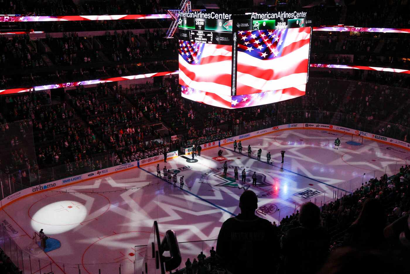 Fans stand for the national anthem before an NHL preseason game between the Dallas Stars and...