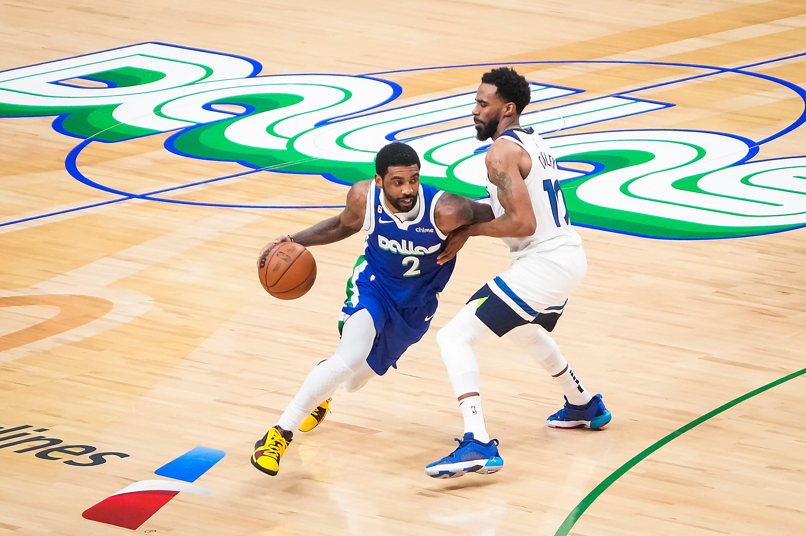 Dallas Mavericks guard Kyrie Irving (2) brings the ball up the court past Minnesota...