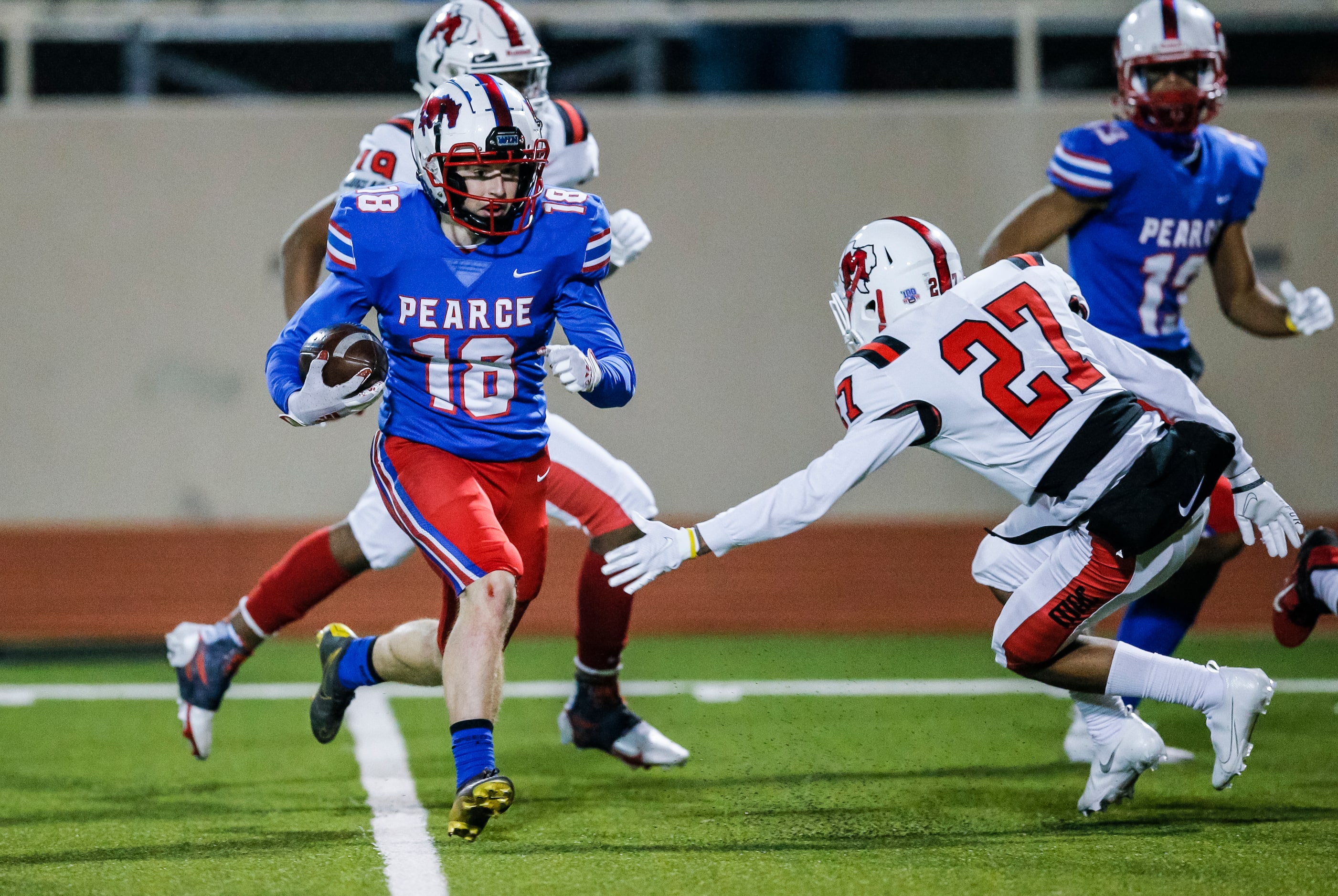 JJ Pearce junior running back Adam Velin (18) avoids a tackle by Irving MacArthur junior...