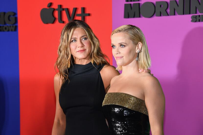 Actresses Jennifer Aniston (left) and Reese Witherspoon arrive for Apple's global premiere...