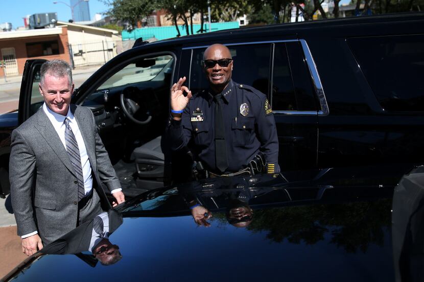 Dallas Police Chief David Brown makes a hand gesture alongside Bobby Baillargeon (left),...