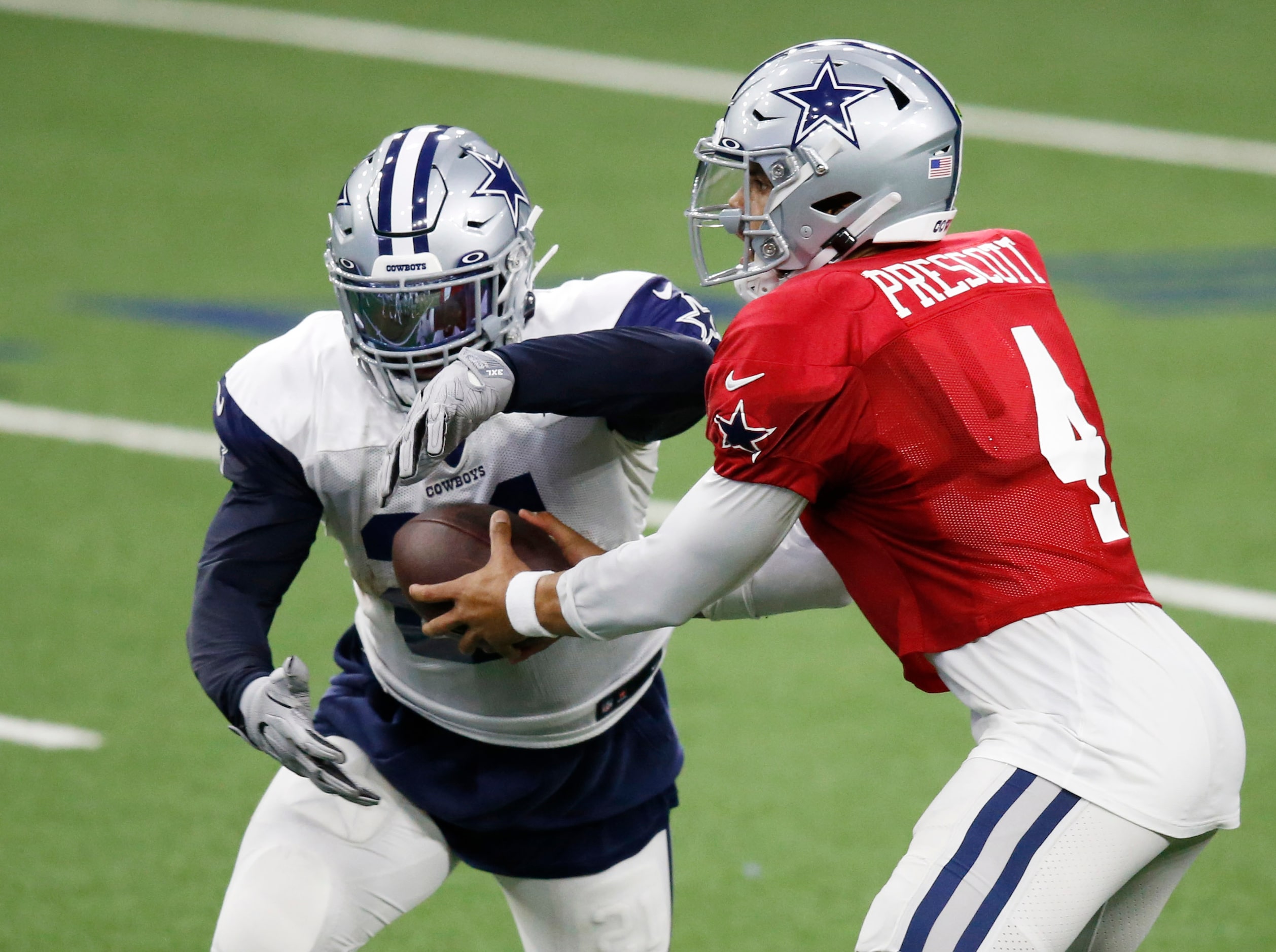 Dallas Cowboys quarterback Dak Prescott (4) hands the ball off to Dallas Cowboys running...