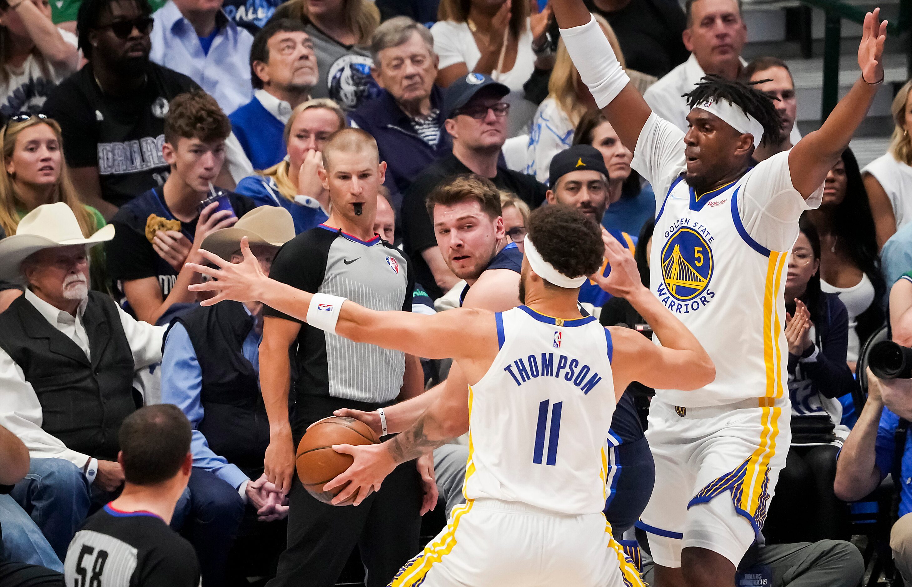 Golden State Warriors guard Klay Thompson (11) and center Kevon Looney (5) defend against...