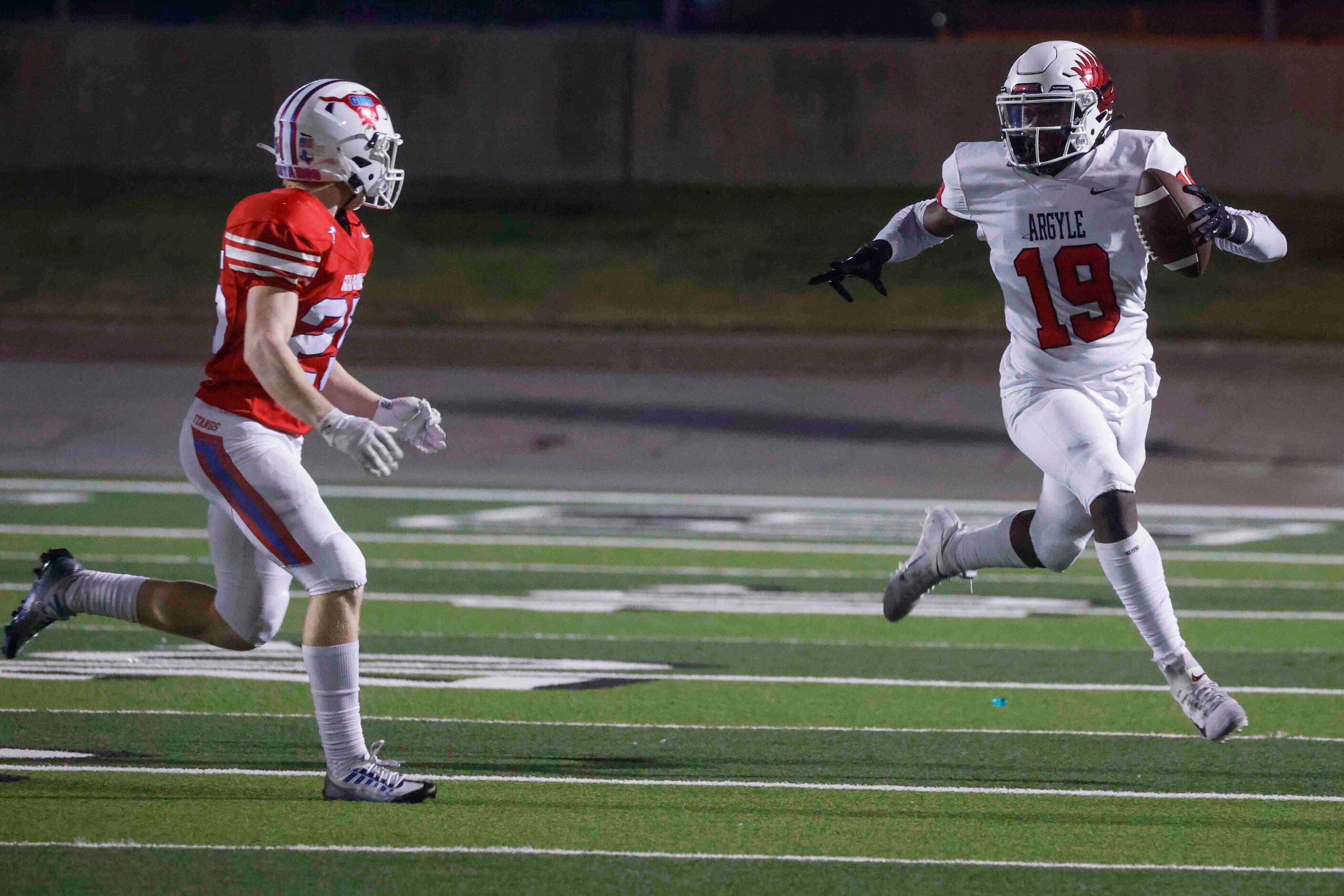 Argyle High’s Jaaqwan (19), runs for a yardage past against Grapevine High’s Hunter Lasher...
