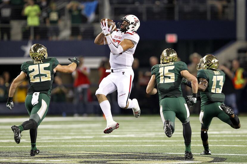 What appears as a pass completion by Texas Tech Red Raiders tight end Jace Amaro (22) is an...