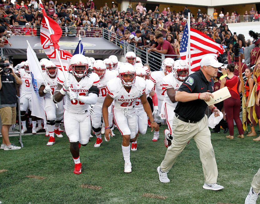 SAN MARCOS, TX - SEPTEMBER 24: Head coach Tom Herman of the Houston Cougars leads his team...