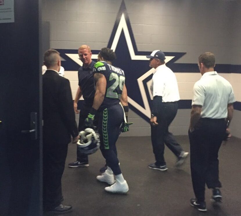 Seahawks safety Earl Thomas talks to Jason Garrett outside the Cowboys locker room after...