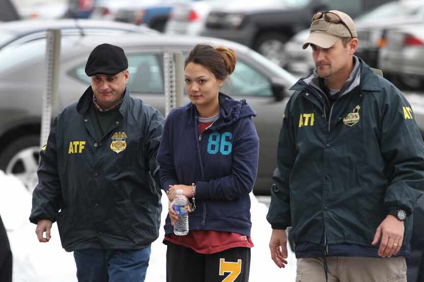 Dawn Nguyen is escorted into the Federal Building, Friday, Dec. 28, 2012, in Rochester,...
