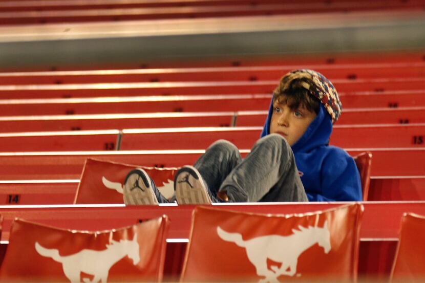 A young SMU fan stays to the very end of the Ponies' 75-31 loss to Navy during the Navy...