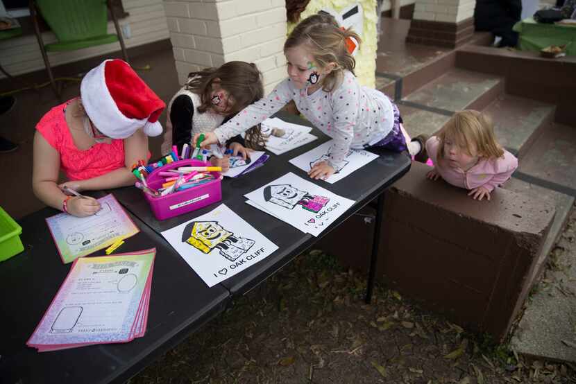 From left, Nova Ayala, 8, writes a letter to Santa Claus as sisters Lucy Shearer, 6, and...