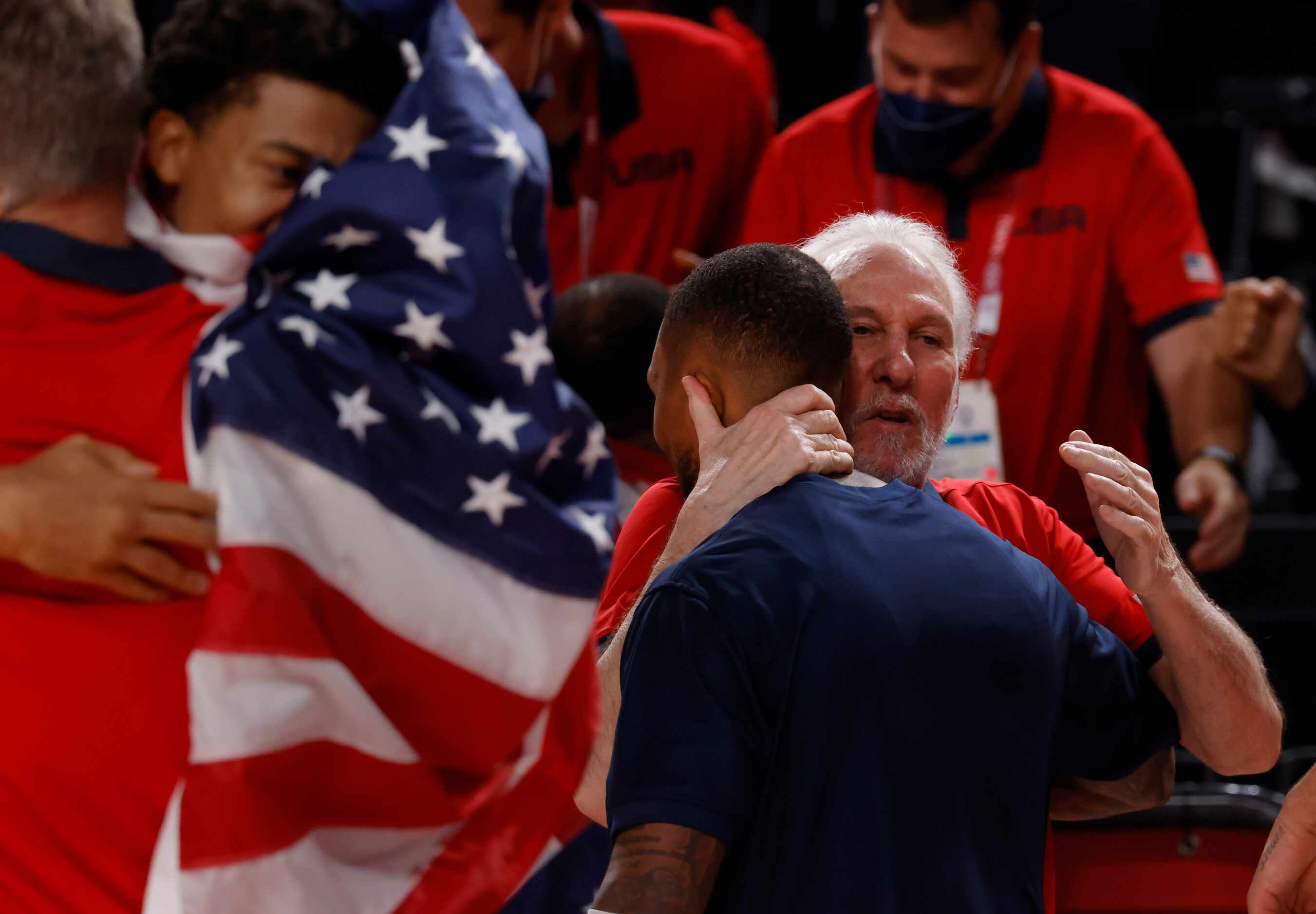 USA’s head coach Gregg Popovich hugs Damian Lillard (6) after they defeated France in the...