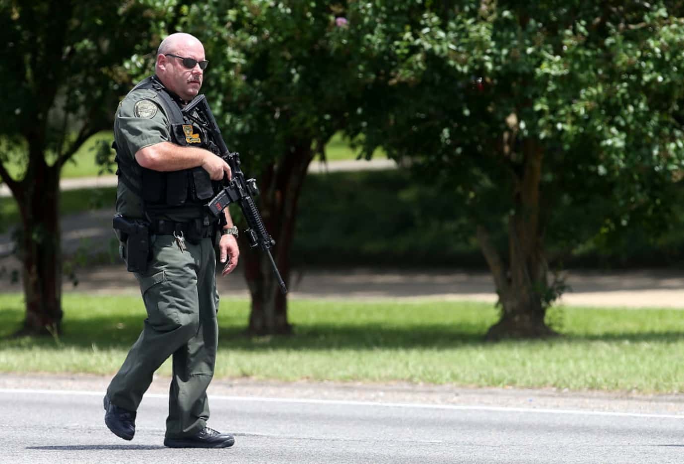 Baton Rouge Police officers patrol Airline Highway after three police officers were killed...