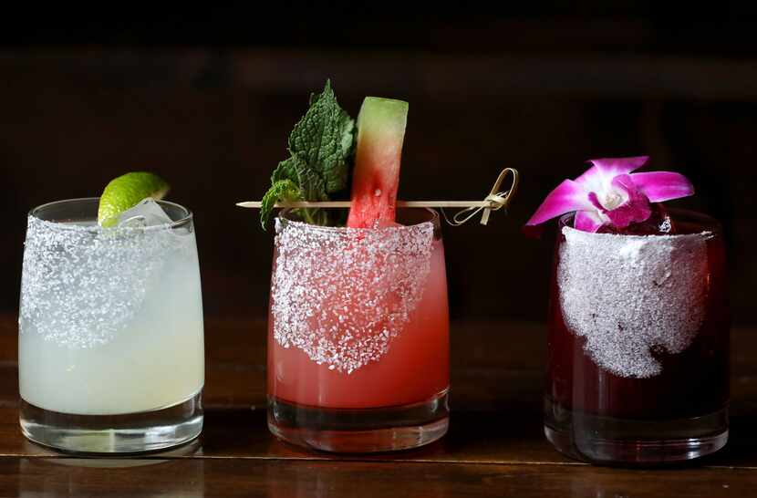 From left, the classic margarita, the Machete, and the hibiscus margarita at Mexican Sugar...