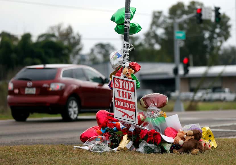 A memorial of flowers and balloons were placed where ex-NFL player Joe McKnight was killed...