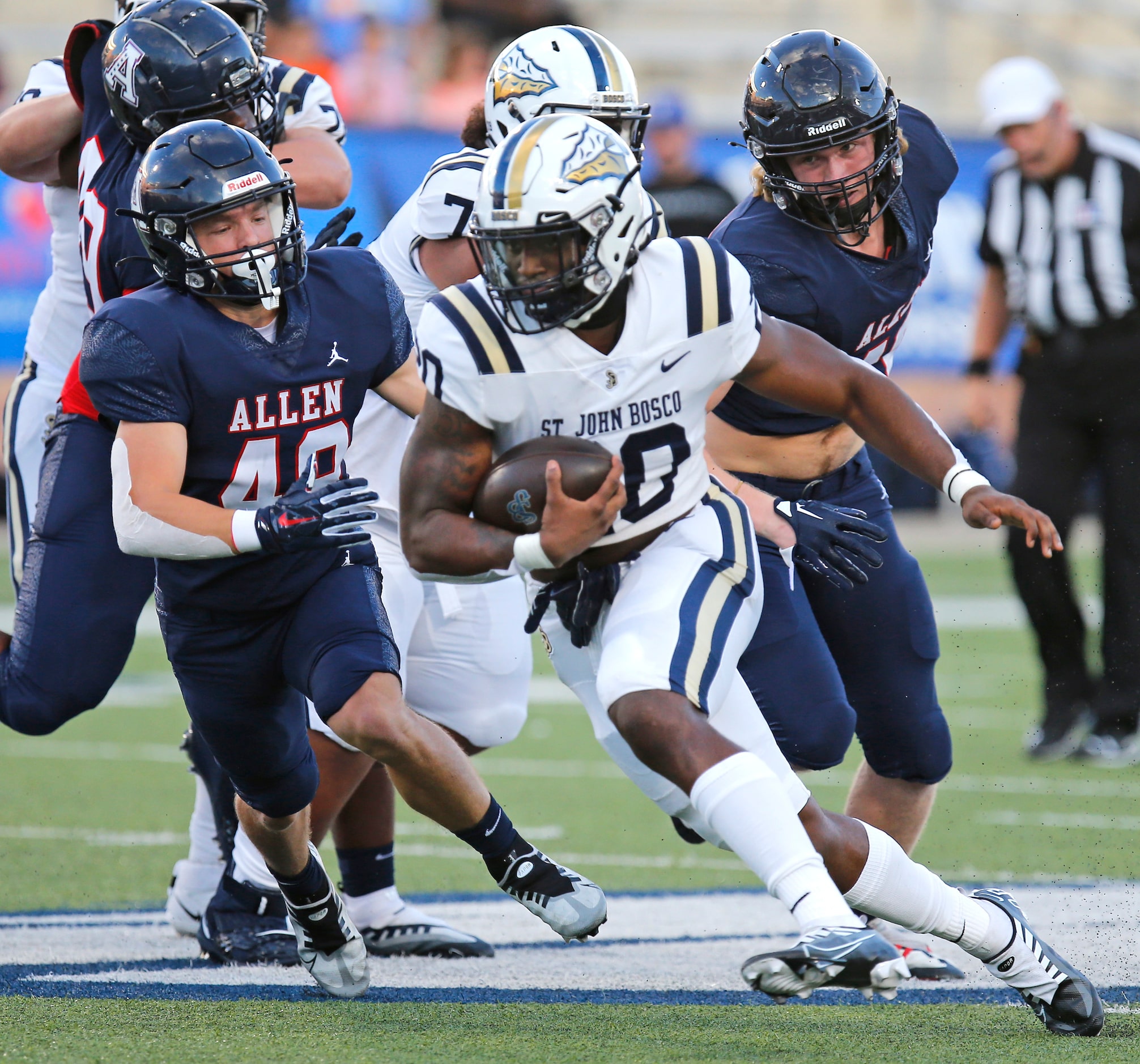 St. John Bosco High School running back Cameron Jones (20) eludes Allen High School...