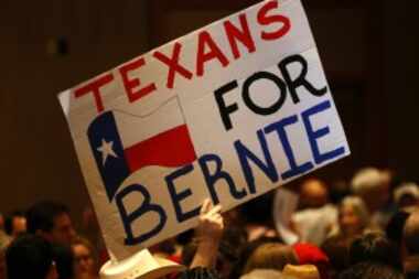  Signs supporting Democratic presidential candidate Bernie Sanders at the Sheraton Dallas on...