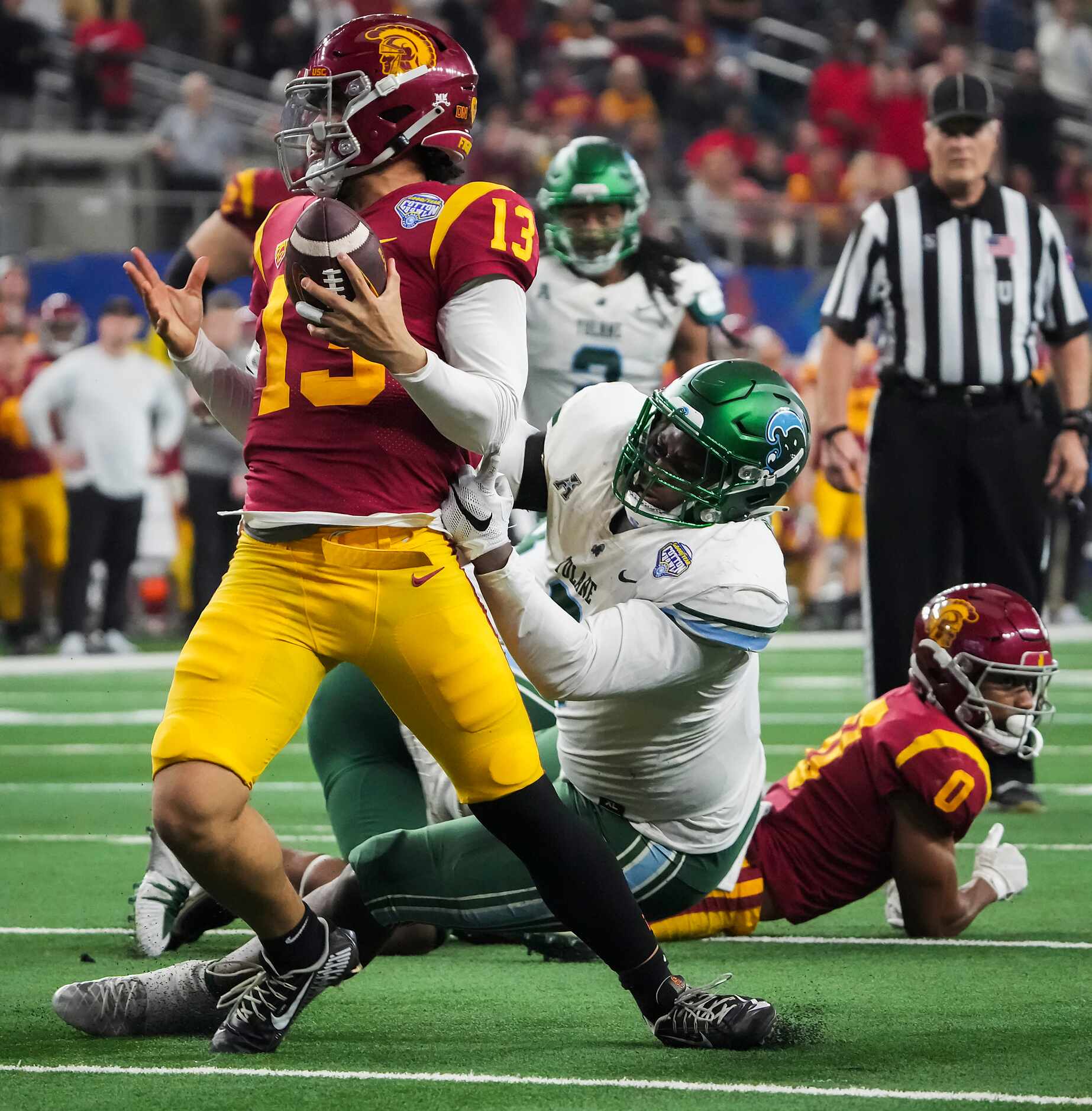 USC quarterback Caleb Williams (13) tries to escape Tulane linebacker Darius Hodges (6) on...