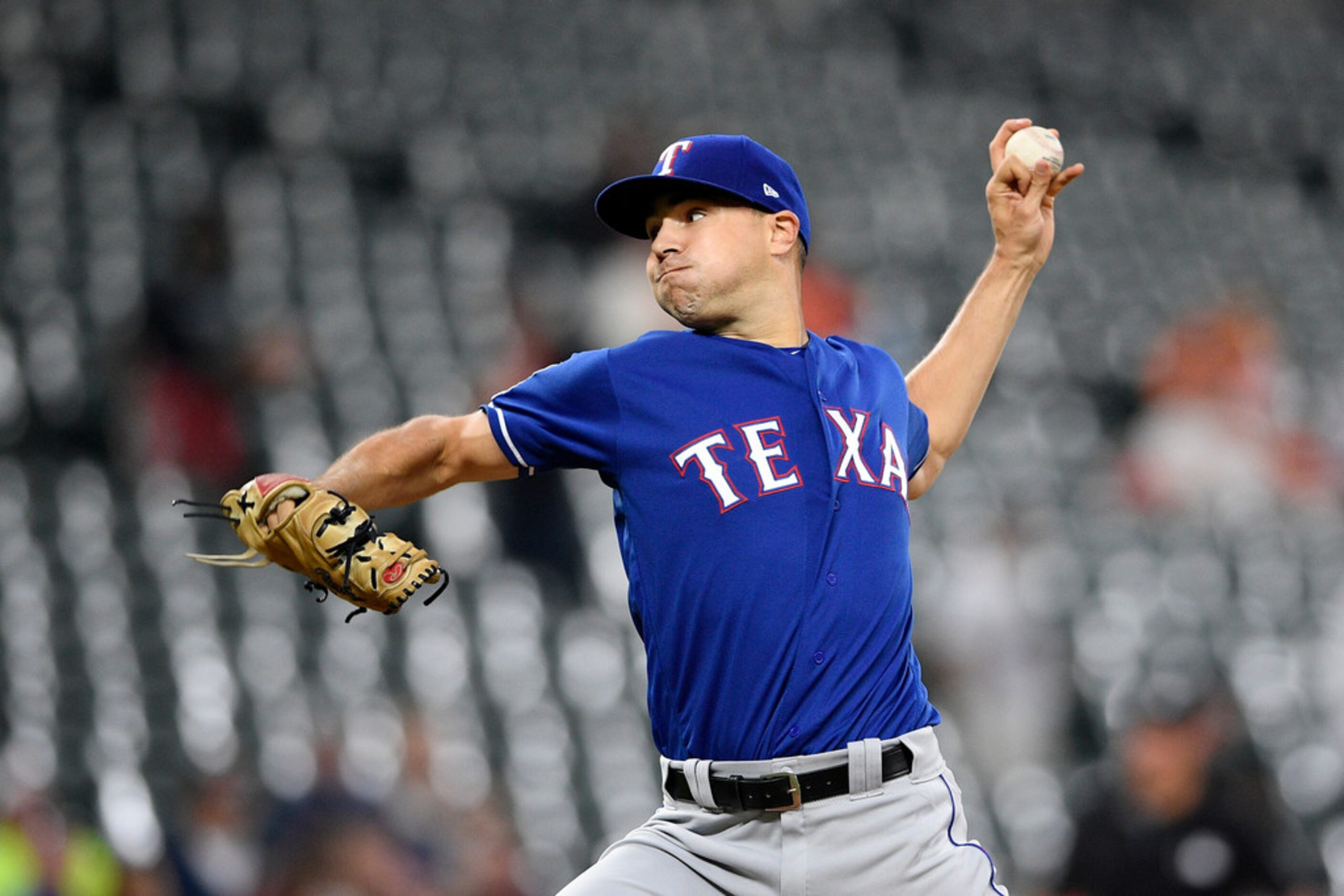 Texas Rangers starting pitcher Brock Burke delivers during the first inning of a baseball...