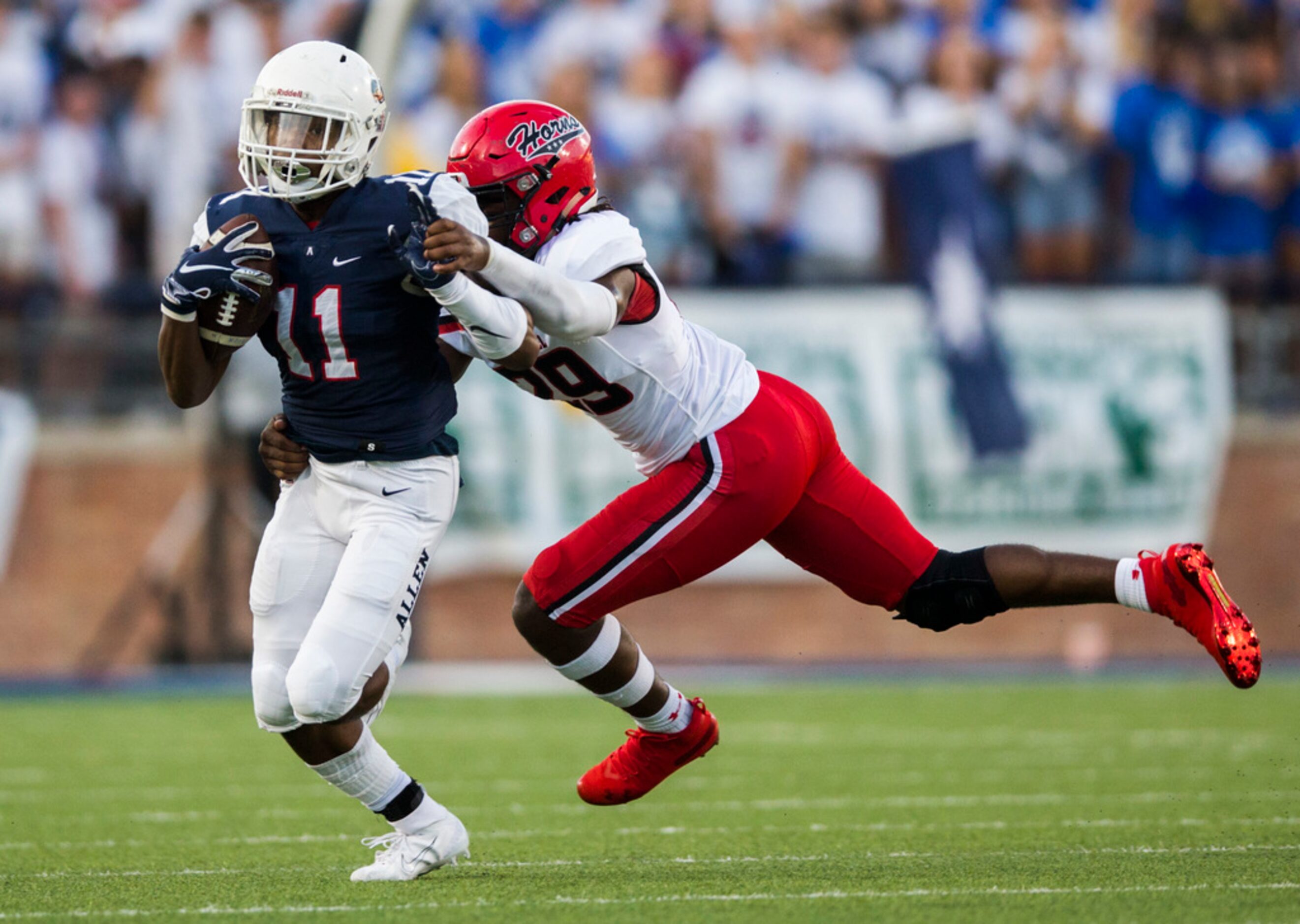 Allen running back Jordan Johnson (11) is tackled by Cedar Hill linebacker Jaheim Lowe (29)...