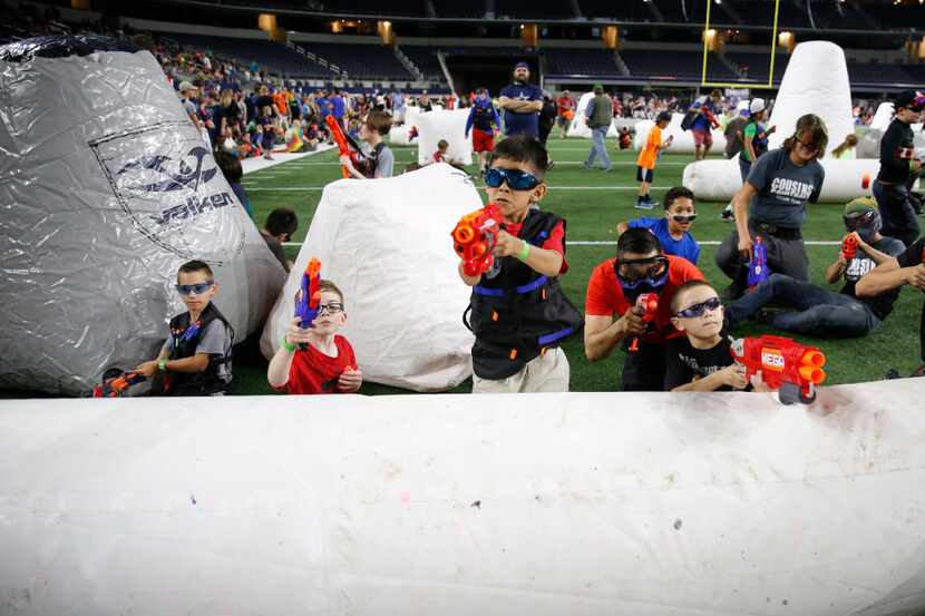 Kids and adults fire Nerf guns during Jared's Epic Nerf Battle 2 at AT&T Stadium in...